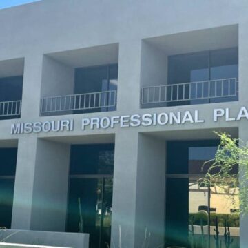 Exterior of Missouri Professional Plaza, a modern two-story building with symmetrical design and greenery.