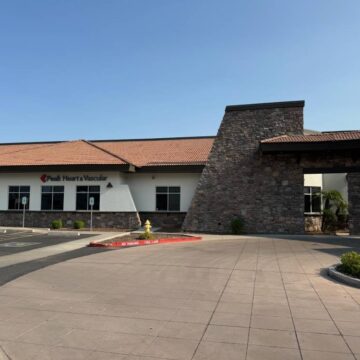South Hearts Vascular modern medical clinic facade with stone column and red lettering.
